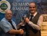 Brian McFerran recieves the McMullan Cup for Most Improved Hurler award on behalf of his son Emmet from Cyril McMullan